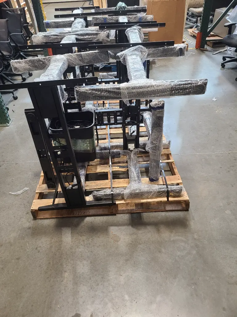 BLACK SIT STAND BASES ON PALLET.webp
